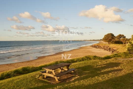 Bench at Ninety Mile Beach in Ahipara, Northland, New Zealand - Peaceful picknick on the famous Northland beach before sunset                               