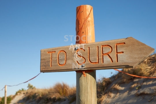 Surf sign - Go surfing! Inviting sign close to a New Zealand surf beach - Ruakaka, Northland, New Zealand                               