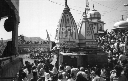 At the Kumbh Mela Festival in Haridwar, India - Vintage low resolution black & white photo of the famous Hindu festival in 1998, with crowds of people around the central river temple