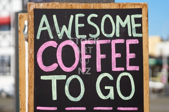 Awesome coffee to go sign - Cafe outdoor advertising with handwriting on a black chalkboard - Wellington, New Zealand                               