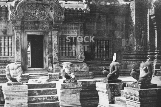 Banteay Srei statues - Statues in front of the beautiful temple near Angkor Wat, before renovations and still headless from Khmer Rouge vandalism - black & white vintage low resolution photo from March 1992