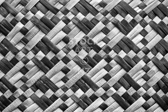 Black and white flax weaving closeup of a kete whakairo  - Background or wall art picture 