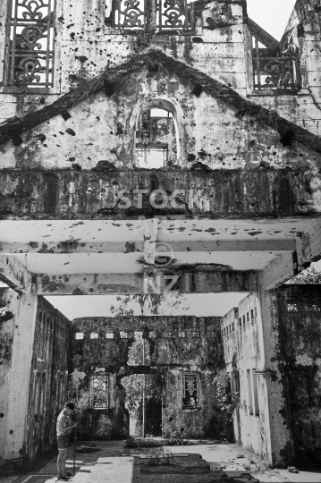 Bullet ridden church in Quang Tri, Vietnam - A boy in the ruins of Long Hung Church in the DMZ area, which was destroyed during the Vietnam War - old vintage black & white low resolution photo from 1994