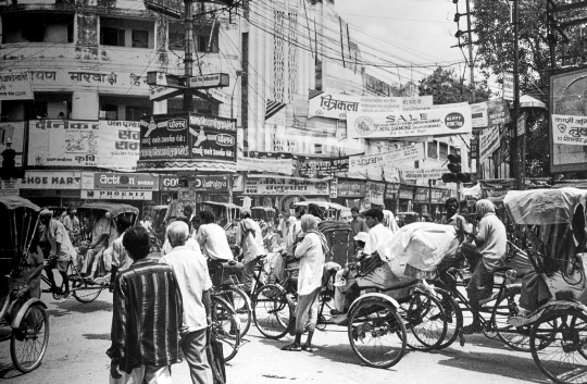 Calcutta street scene in 1994 - Old traffic scene at a busy intersection with rickshaws and billboards, in downtown Kolkata - vintage low resolution black & white photo