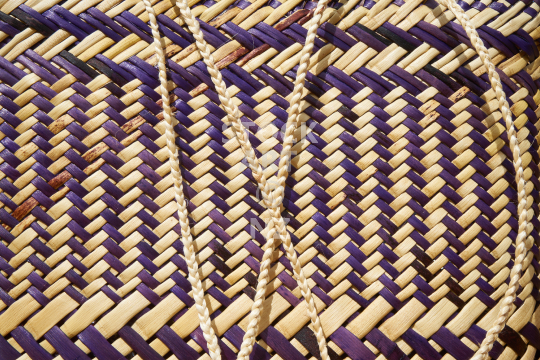 Closeup of a New Zealand kete  - Purple and natural colour, vertical twill with split weaving