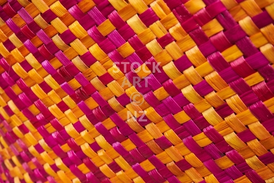 Closeup of orange magenta flax weaving