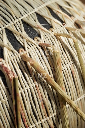 Closeup of shiny muka and pokinikini - New Zealand flax weaving 
