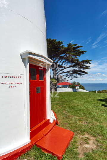 Closeup of the red entrance door of the Tiritiri Matangi lighthouse - Manufactured by Simpson & Co, Pimlico London