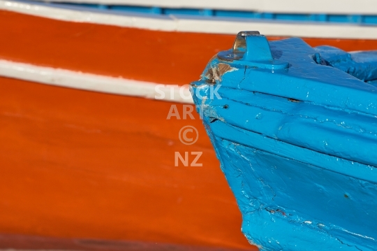 Closeup of traditional red and blue fishing boats - Colourful harbour scene in Ischia Ponte, Golfo di Napoli, Italy                               