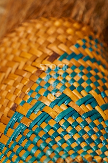 Colourful closeup of flax weaving - Woven kahu with golden yellow and turquoise colours