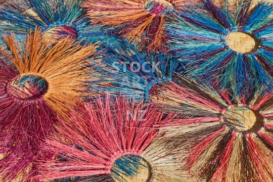 Colourful shredded flax circles - Shredded dyed flax fibres woven into round circles with vibrant colours 
