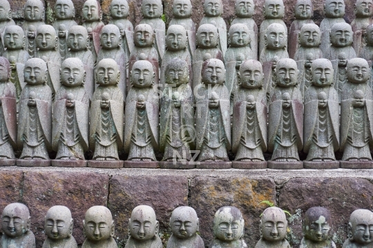 Dozens of Japanese Jizo bodhisattva statues - Hase Dera temple in Kamakura, Japan