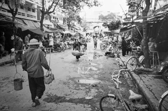 Hanoi street scene from 1994 - Vietnam - Typical scene with people, street sellers and bicycles - old vintage black & white low resolution photo