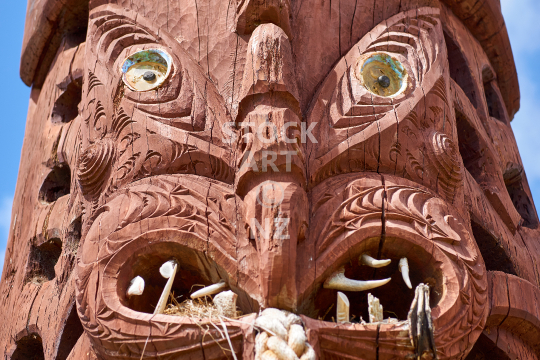 Maori carving in Kawhia - Carved wooden sculpture displayed in the little harbour village in the Waikato, New Zealand