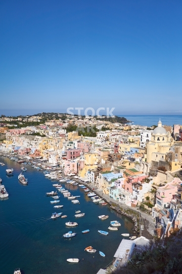 Marina Corricella with blue sky - The famous fisherman village in Procida Island, Bay of Naples, Italy                               