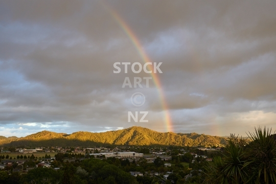 Mount Parihaka - Whangarei, Northland, New Zealand - Extinct volcano with native bush scenic reserve, seen from Kensington with rainbow at sunset