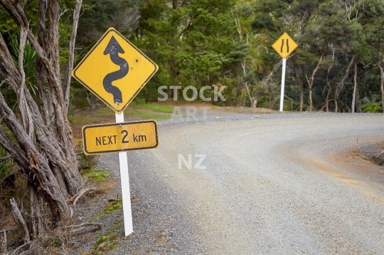 New Zealand gravel road with warning sign