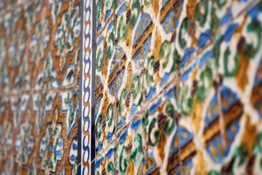 Old medieval tiles in Seville’s Royal Palace, Spain