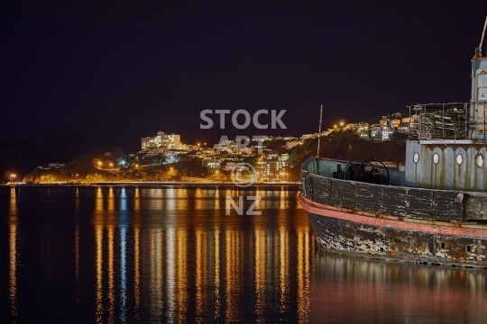 Old ship rocking in Wellington Harbour at night - Night scene of the water in the bay of New Zealand’s capital city, view to Roseneath