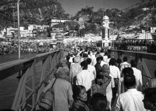 On the bridge with pilgrims to the Kumbh Mela Festival in Haridwar, India - Vintage low resolution black & white photo of the largest Hindu festival in 1998