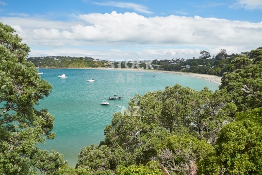 Oneroa Bay on Waiheke Island - Auckland, NZ - Main beach with lush pohutukawa trees, on the offshore island off the Auckland coast, an exclusive and beautiful tourist destination