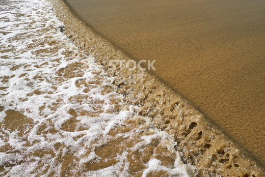 Sandy wave on a New Zealand beach - Swirly water at Baylys Beach, Northland’s west coast, NZ