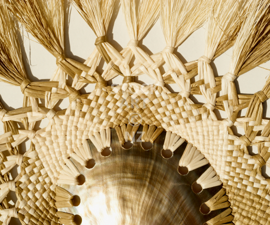 Splashback photo: Closeup of a Polynesian fan made of coconut fibre with mother of pearl shell