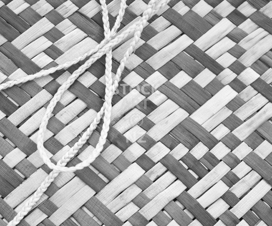 Splashback photo: Closeup of a woven flax kete whakairo - New Zealand flax weaving - Black & white kitchen splashback photo for standard size 900 x 750 mm