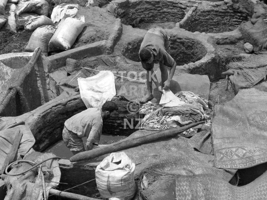 Tanning in Marrakesh, Morocco - Process of workers dying leather the traditional way - vintage black & white lower resolution stock photo, ideal for web use