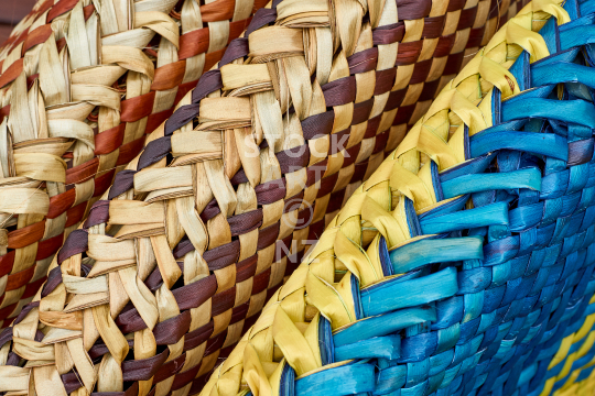 Underside of three colourful flax kete - New Zealand flax weaving