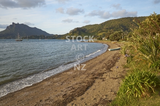 Urquharts Bay at sunset  - Beach with boats and a view to Mount Manaia - Whangarei Heads, Northland, NZ